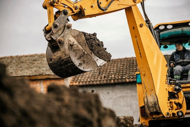 A man is operating a mini excavator