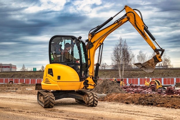 A man is operating a mini excavator.